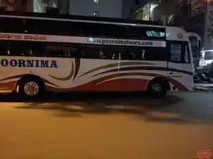 Poornima Tours Bus-Side Image